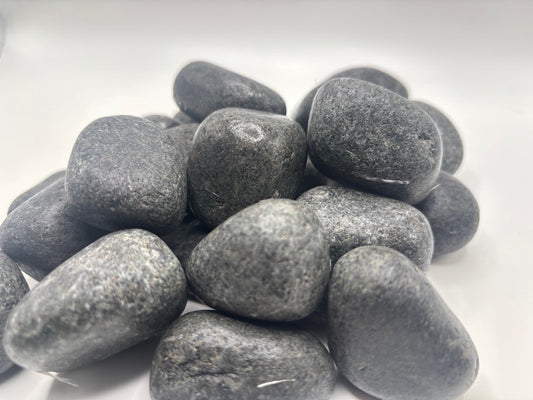 Close-up of dark Black granite stones on a white background