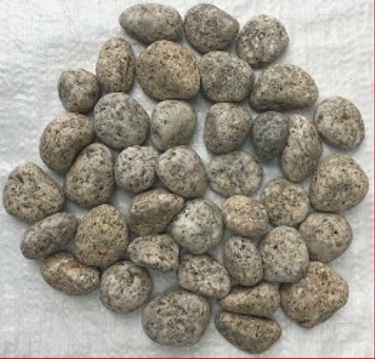 20-30 mm Gold Granite Pebbles on a textured surface