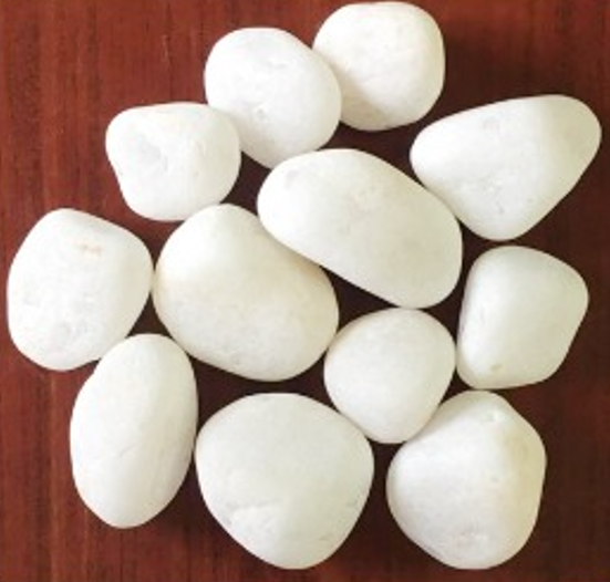 30-50mm White Quartz Pebbles on a wooden surface