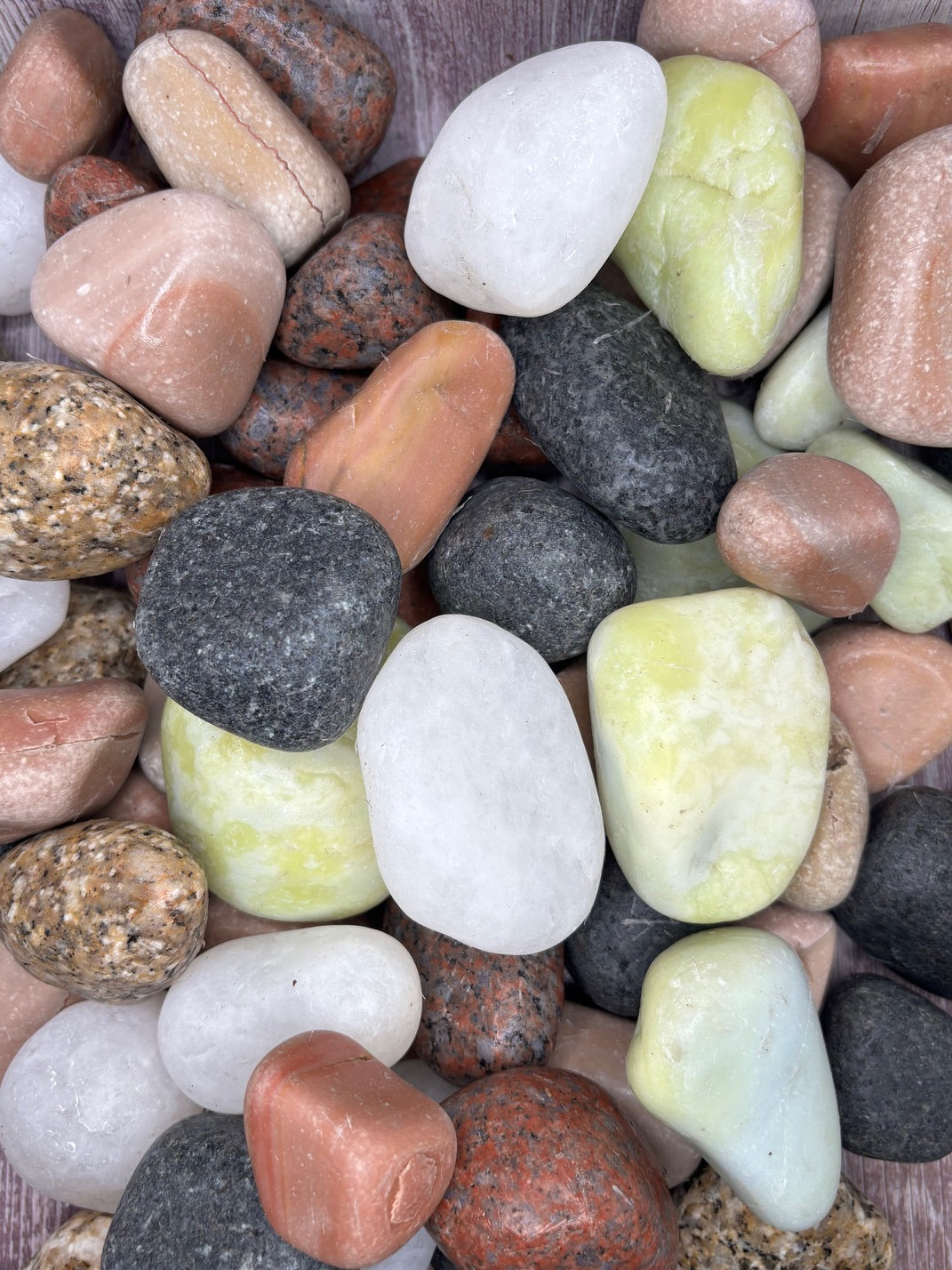 Assorted colorful pebbles and stones of various sizes, color, and shapes.