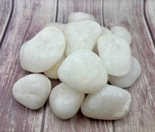 White Quartz Pebbles on  a grey background for landscaping